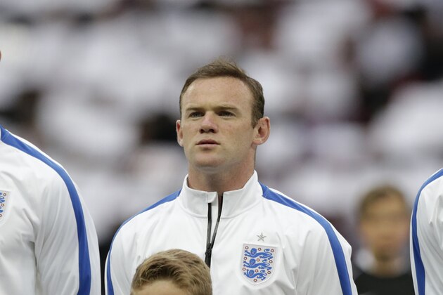 England's Wayne Rooney stands in a team line up during the playing of the national anthems before the international friendly soccer match between England and Peru at Wembley Stadium in London, Friday, May 30, 2014.  (AP Photo/Matt Dunham)
