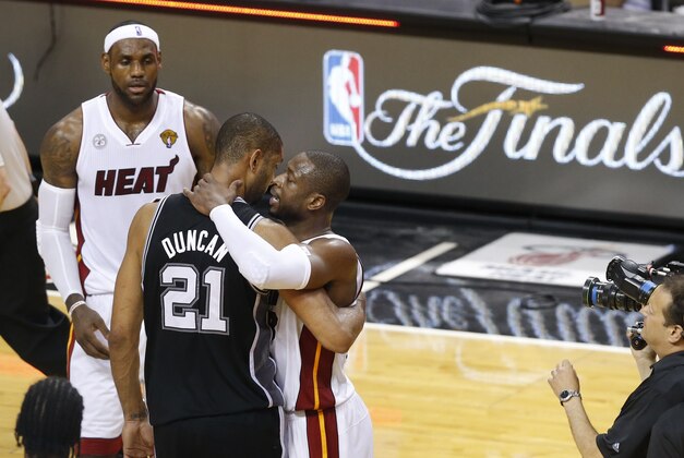 Jun 20, 2013; Miami, FL, USA; Miami Heat shooting guard Dwyane Wade (3) hugs San Antonio Spurs power forward Tim Duncan (21) as LeRon James (6) looks on after game seven in the 2013 NBA Finals at American Airlines Arena. Miami defeated San Antonio 95-88 to win the NBA Championship. Mandatory Credit: Derick E. Hingle-USA TODAY Sports