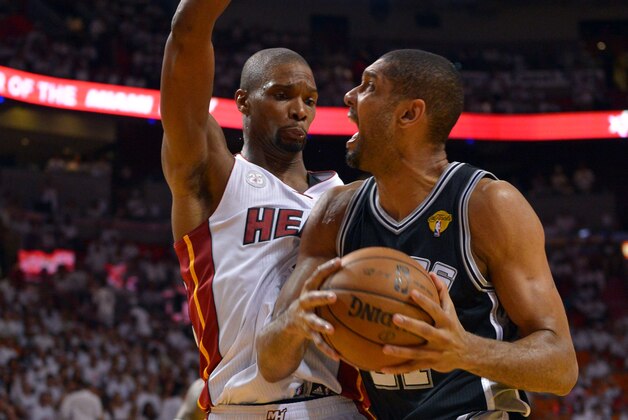 Jun 20, 2013; Miami, FL, USA; San Antonio Spurs power forward Tim Duncan (21) drives against Miami Heat center Chris Bosh (1) during the third quarter of game seven in the 2013 NBA Finals at American Airlines Arena. Mandatory Credit: Steve Mitchell-USA TODAY Sports