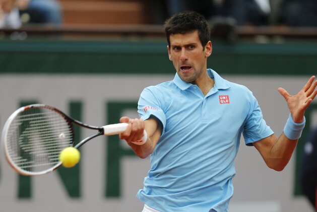 Serbia's Novak Djokovic returns the ball to France's Jo-Wilfried Tsonga during their fourth round match of  the French Open tennis tournament at the Roland Garros stadium, in Paris, France, Sunday, June 1, 2014. Djokovic won 6-1, 6-4, 6-1. (AP Photo/David Vincent)