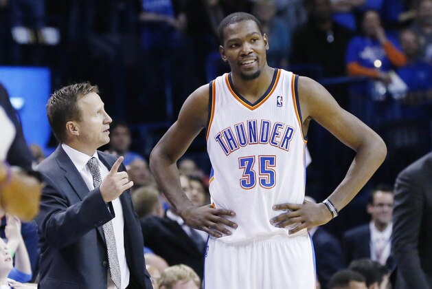 Oklahoma City Thunder head coach Scott Brooks and forward Kevin Durant (35) talks in the fourth quarter of an NBA basketball game against the Denver Nuggets in Oklahoma City, Monday, Nov. 18, 2013. Oklahoma City won 115-113. (AP Photo/Sue Ogrocki)