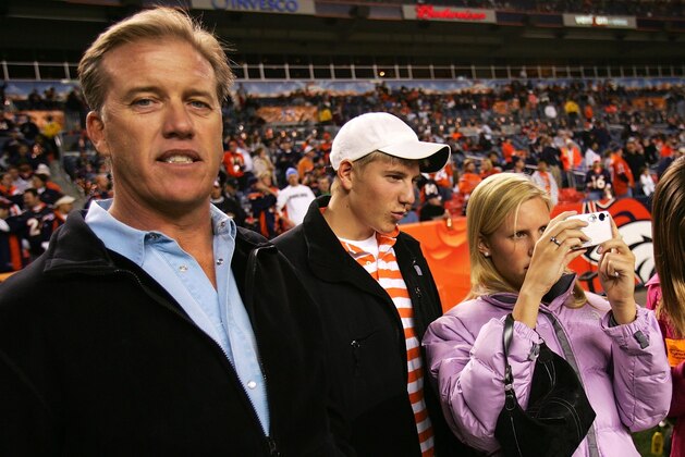 DENVER - JANUARY 14:  Former Denver Broncos quarterback John Elway stands on the field with his kids (L-R) Jack, Jordan and Juliana before a Divisional Playoff game against the New England Patriots on January 14, 2006 at Invesco Field at Mile High in Denver, Colorado.  (Photo by Doug Pensinger/Getty Images)