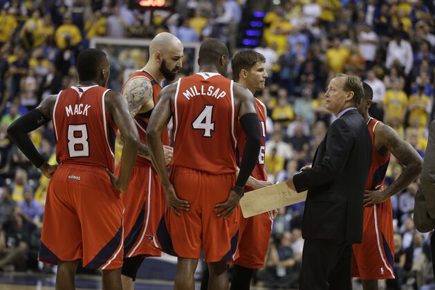 Atlanta Hawks head coach Mike Budenholzer talks with his team during the second half in Game 5 of an opening-round NBA basketball playoff series against the Indiana Pacers  Monday, April 28, 2014, in Indianapolis. Atlanta defeated Indiana 107-97. (AP Photo/Darron Cummings)