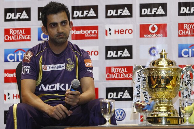 Kolkata Knight Riders captain Gautam Gambhir sits next to the winning trophy of the Indian Premier League (IPL) during a photo call on the eve of the final match against Chennai Super Kings, in Chennai, India, Saturday, May 26, 2012. (AP Photo/Aijaz Rahi)