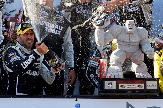 DOVER, DE - JUNE 01:  Jimmie Johnson, driver of the #48 Lowe's/Kobalt Tools Chevrolet, celebrates with champagne in Victory Lane after winning the NASCAR Sprint Cup Series FedEx 400 Benefiting Autism Speaks at Dover International Speedway on June 1, 2014 in Dover, Delaware.  (Photo by Drew Hallowell/Getty Images)