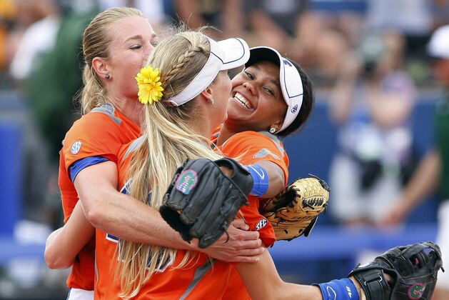 Florida pitcher Hannah Rogers, Taylor Schwarz, front, and Kelsey Stewart, right, celebrate after defeating Baylor during an NCAA women's softball College World Series tournament game, Sunday, June 1, 2014, in Oklahoma City. Florida won 6-3. (AP Photo/Alonzo Adams)