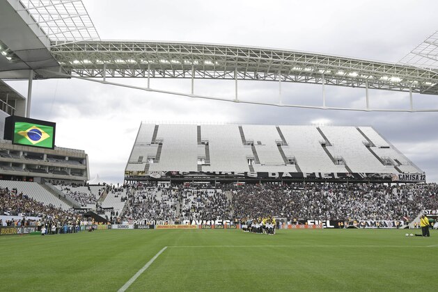 Corinthians's and Botafogo players listen to the national anthem prior to a Brazilian soccer league match at the Itaquerao, the stadium that will host the World Cup opener match between Brazil and Croatia on June 12, in Sao Paulo, Brazil, Sunday, June 1, 2014. (AP Photo/Andre Penner)