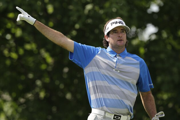 Bubba Watson points to the direction of his tee shot on the 14th hole during the final round of the Memorial golf tournament on Sunday, June 1, 2014, in Dublin, Ohio. (AP Photo/Jay LaPrete)