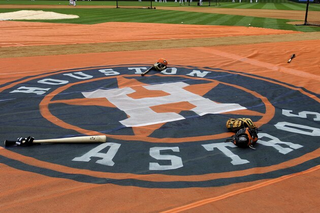 Baseball bats and gloves sit on the tarp with the new Houston Astros logo during batting practice before an exhibition baseball game against the Chicago Cubs Friday, March 29, 2013, in Houston. (AP Photo/Pat Sullivan) Baseball bats and gloves sit on the tarp with the new Houston Astros logo during batting practice before an exhibition baseball game against the Chicago Cubs Friday, March 29, 2013, in Houston. (AP Photo/Pat Sullivan)