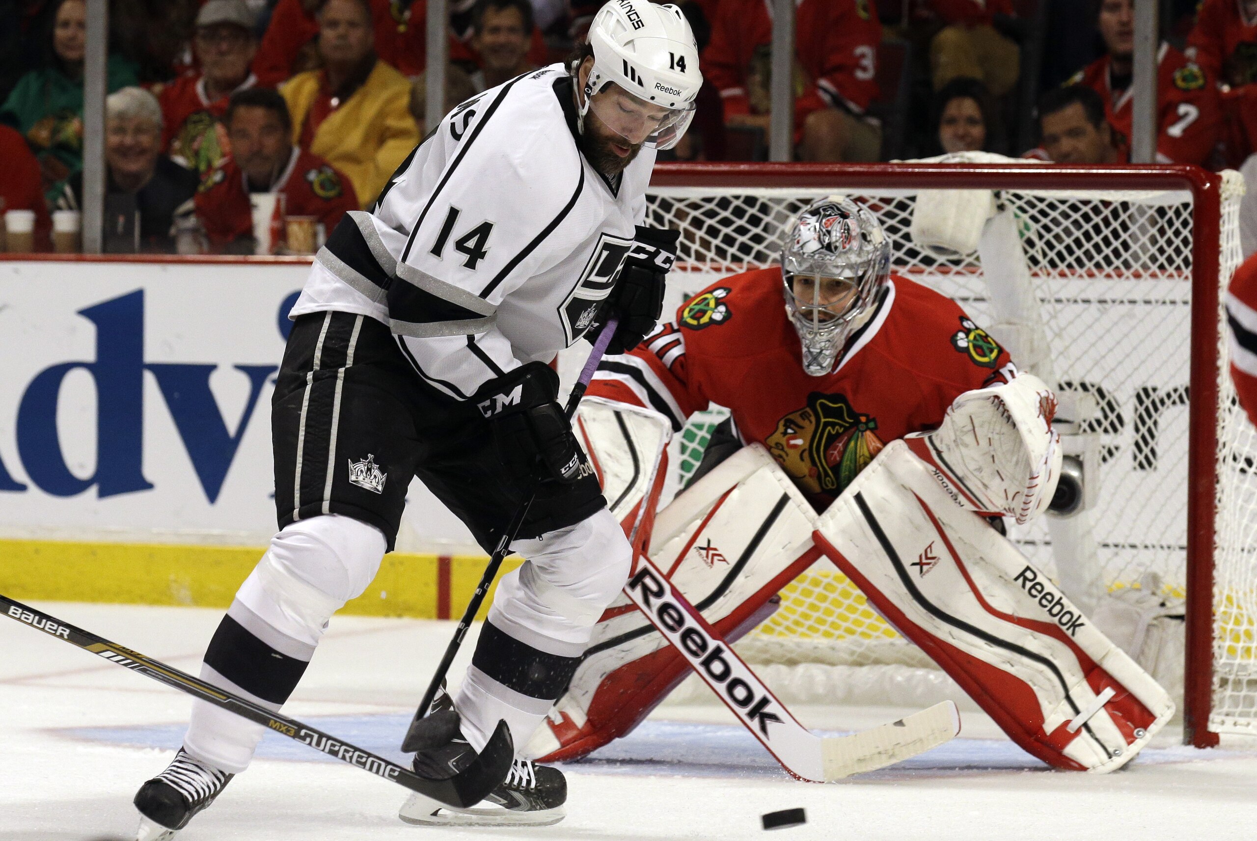 Los Angeles Kings right wing Justin Williams (14) attempts to shoot against Chicago Blackhawks goalie Corey Crawford (50) during the first period in Game 7 of the Western Conference finals in the NHL hockey Stanley Cup playoffs Sunday, June 1, 2014, in Chicago. (AP Photo/Nam Y. Huh)