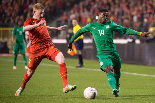 Belgium's Kevin De Bruyne, left, challenges Ivory Coast's Serge Aurier during a friendly soccer match at the King Baudouin stadium in Brussels on Wednesday March 5, 2014. (AP Photo/Geert Vanden Wijngaert)