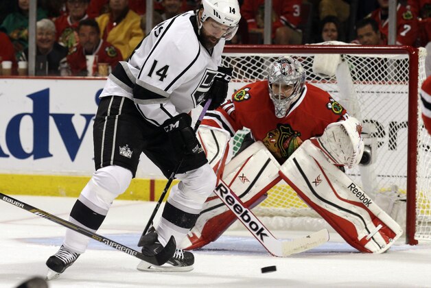 Los Angeles Kings right wing Justin Williams (14) attempts to shoot against Chicago Blackhawks goalie Corey Crawford (50) during the first period in Game 7 of the Western Conference finals in the NHL hockey Stanley Cup playoffs Sunday, June 1, 2014, in Chicago. (AP Photo/Nam Y. Huh)