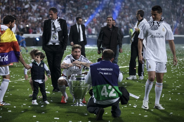 Real Madrid's Sergio Ramos poses with the Champion Leagues trophy during celebrations at the Santiago Bernabeu stadium, in Madrid, Spain, Sunday, May 25, 2014, after their team won the Champions League final soccer match in Lisbon, Portugal by beating Atletico Madrid. (AP Photo/Gabriel Pecot)