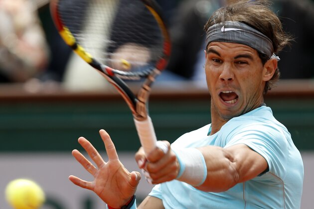 Spain's Rafael Nadal returns the ball to Serbia's Dusan Lajovic during their fourth round match of  the French Open tennis tournament at the Roland Garros stadium, in Paris, France, Monday, June 2, 2014. (AP Photo/Darko Vojinovic)