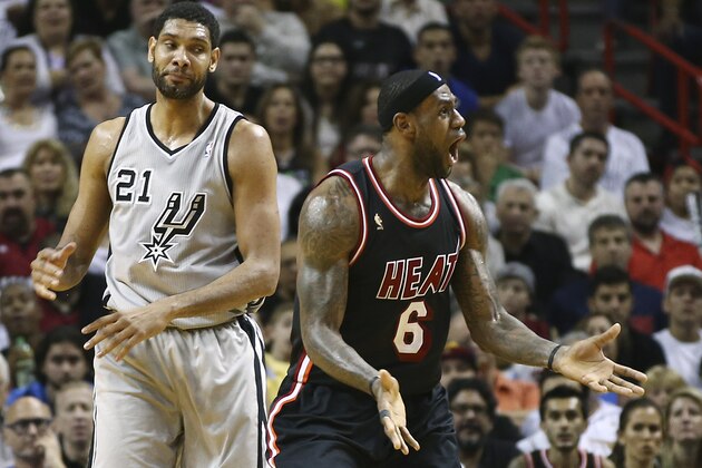 After fouling San Antonio Spurs' Tim Duncan (21), Miami Heat's LeBron James (6) reacts as he is charged with a technical foul also, during the second half of an NBA basketball game in Miami, Sunday, Jan. 26, 2014. The Heat won 113-101. (AP Photo/J Pat Carter)