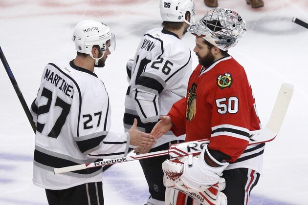 Los Angeles Kings defenseman Alec Martinez (27) shakes hands with Chicago Blackhawks goalie Corey Crawford (50) after the Kings defeated the Blackhawks 5-4 in the overtime period in Game 7 of the Western Conference finals in the NHL hockey Stanley Cup playoffs Sunday, June 1, 2014, in Chicago. (AP Photo/Charles Rex Arbogast)
