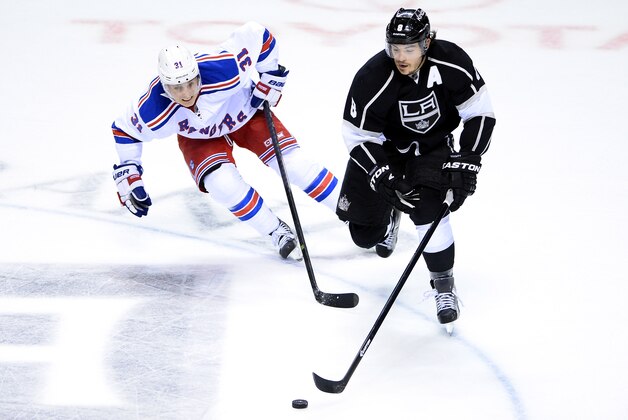 LAS VEGAS, NV - SEPTEMBER 27:  Drew Doughty #8 of the Los Angeles Kings brings the puck up the ice as Jesper Fast #31 of the New York Rangers defends during a preseason game at the MGM Grand Garden Arena on September 27, 2013 in Las Vegas, Nevada. Los Angeles won 4-1.  (Photo by Ethan Miller/Getty Images)