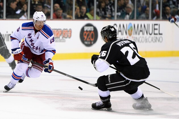 LAS VEGAS, NV - SEPTEMBER 27:   Brad Richards #19 of the New York Rangers brings the puck up the ice against Slava Voynov #26 of the Los Angeles Kings during their preseason game at the MGM Grand Garden Arena on September 27, 2013 in Las Vegas, Nevada. Los Angeles won 4-1.  (Photo by Ethan Miller/Getty Images)