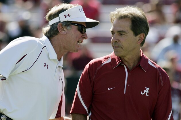 FILE - In this file photo taken Oct. 9, 2010, Alabama coach Nick Saban, right, talks with South Carolina coach Steve Spurrier before the start of an NCAA college football game in Columbia, S.C. Spurrier has a plan to pay players, and it wouldn't cost schools or conferences a dime. South Carolina's head ball coach offered an interesting yet far-from-feasible proposal Wednesday, June 1, 2011, that would give 70 players $300 every game for expenses. (AP Photo/Mary Ann Chastain, File)