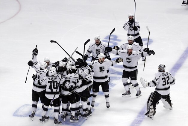 Los Angeles Kings celebrate after defeating Chicago Blackhawks 5-2 in the overtime period in Game 7 of the Western Conference finals in the NHL hockey Stanley Cup playoffs Sunday, June 1, 2014, in Chicago. (AP Photo/Charles Rex Arbogast)