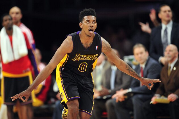 January 31, 2014; Los Angeles, CA, USA; Los Angeles Lakers small forward Nick Young (0) reacts after shooting a three point basket against the Charlotte Bobcats during the first half at Staples Center. Mandatory Credit: Gary A. Vasquez-USA TODAY Sports