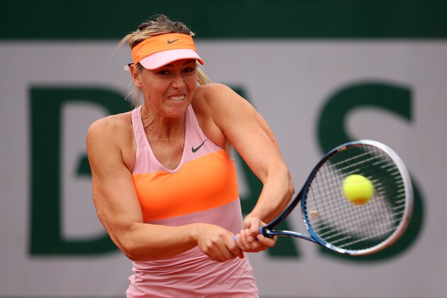 PARIS, FRANCE - JUNE 01:  Maria Sharapova of Russia plays a backhand in her women's singles match against Samantha Stosur of Australia on day eight of the French Open at Roland Garros on June 1, 2014 in Paris, France.  (Photo by Clive Brunskill/Getty Images)