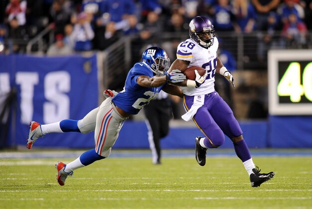 Oct 21, 2013; East Rutherford, NJ, USA; New York Giants defensive back Will Hill (25) dives to tackle Minnesota Vikings running back Adrian Peterson (28) during the first half at MetLife Stadium. Mandatory Credit: Joe Camporeale-USA TODAY Sports