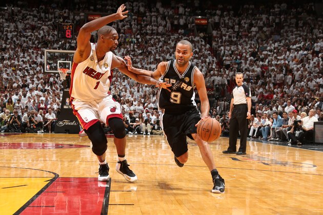 MIAMI, FL - JUNE 18: Tony Parker #9 of the San Antonio Spurs drives against Chris Bosh #1 of the Miami Heat in overtime of Game Six of the 2013 NBA Finals on June 18, 2013 at American Airlines Arena in Miami, Florida. NOTE TO USER: User expressly acknowledges and agrees that, by downloading and or using this photograph, User is consenting to the terms and conditions of the Getty Images License Agreement. Mandatory Copyright Notice: Copyright 2013 NBAE (Photo by Nathaniel S. Butler/NBAE via Getty Images)
