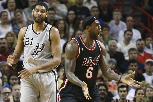 After fouling San Antonio Spurs' Tim Duncan (21), Miami Heat's LeBron James (6) reacts as he is charged with a technical foul also, during the second half of an NBA basketball game in Miami, Sunday, Jan. 26, 2014. The Heat won 113-101. (AP Photo/J Pat Carter)