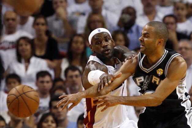 Jun 18, 2013; Miami, FL, USA; San Antonio Spurs point guard Tony Parker (9) passes against Miami Heat small forward LeBron James (6) during the first quarter of game six in the 2013 NBA Finals at American Airlines Arena.  Mandatory Credit: Derick E. Hingle-USA TODAY Sports