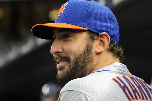 New York Mets starting pitcher Matt Harvey  smiles as he talks with trainer Ray Ramirez before the interleague baseball game against the New York Yankees at Yankee Stadium on Monday, May 12, 2014, in New York. Harvey is recovering from Tommy John surgery. (AP Photo/Kathy Kmonicek)