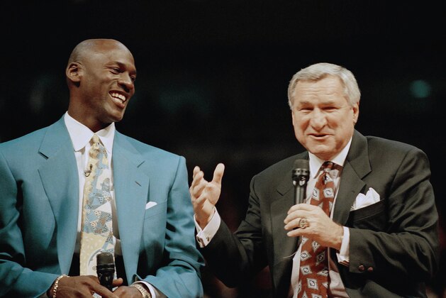 Former Chicago Bulls great Michael Jordan shares a moment with Dean Smith, his former coach at North Carolina during ceremonies honoring Jordan on Tuesday night, Nov. 1, 1994 at Chicago’s United Center. The evening saw Jordan’s number 23 retired and a 12-foot-high bronze statue unveiled outside the stadium. (AP Photo/Pool)
