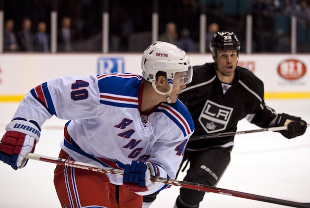 Sep 27, 2013; Las Vegas, NV, USA;  New York Rangers forward Brandon Mashinter (40) looks to evade Los Angeles Kings defenseman Willie Mitchell (33) during an NHL preseason game at MGM Grand Garden Arena. The Kings won the game 4-1. Mandatory Credit: Stephen R. Sylvanie-USA TODAY Sports