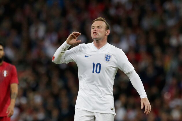 England's Wayne Rooney shouts instructions to a teammate during the international friendly soccer match between England and Peru at Wembley Stadium in London, Friday, May 30, 2014.  (AP Photo/Matt Dunham)