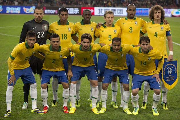 FILE - In this Oct. 15, 2013 file photo, Brazil soccer team poses prior to the start their  international friendly soccer match against Zambia at the Bird's Nest national stadium in Beijing, China. Background from left: Diego Cavalier, Paulinho, Ramires, Lucas, Anderson Dede, and David Luiz. Foreground from left: Neymar, Dani Alves, Alexandre Pato, Lucas Moura and Maxwell.  (AP Photo/Ng Han Guan, File)