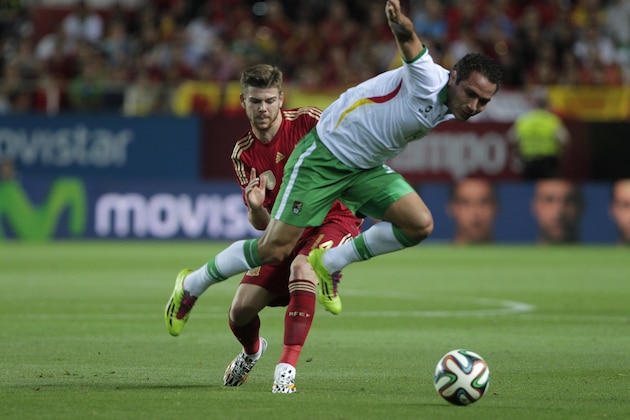 Spain's Alberto Moreno, rear, and Bolivia's Gualberto Mojica, vie for the ball during their friendly soccer match in Seville, on Friday, May 30. 2014. (AP Photo/Miguel Angel Morenatti)