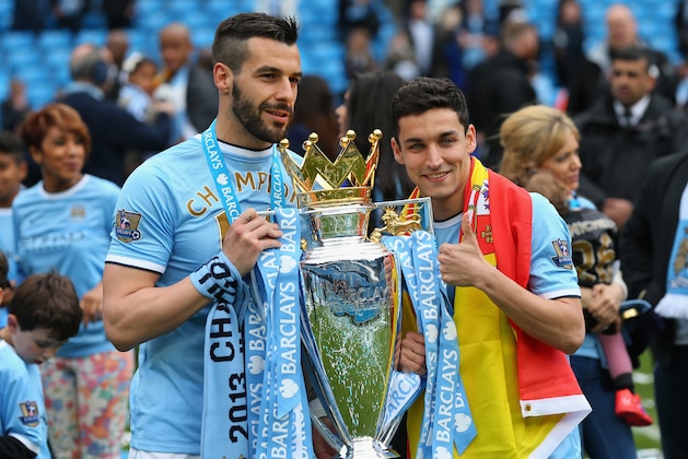 MANCHESTER, ENGLAND - MAY 11:  Alvaro Negredo of Manchester City and Jesus Navas (R) pose with the trophy at the end of the Barclays Premier League match between Manchester City and West Ham United at the Etihad Stadium on May 11, 2014 in Manchester, England.  (Photo by Alex Livesey/Getty Images)