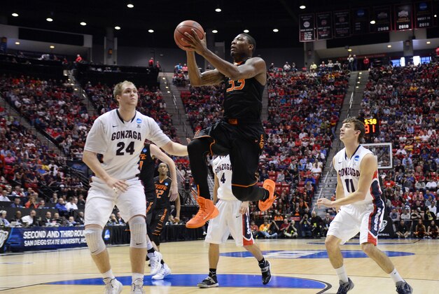Mar 21, 2014; San Diego, CA, USA; Oklahoma State Cowboys guard Marcus Smart (33) shoots between Gonzaga Bulldogs center Przemek Karnowski (24) and guard David Stockton (11) in the first half of a men's college basketball game during the second round of the 2014 NCAA Tournament at Viejas Arena. Mandatory Credit: Christopher Hanewinckel-USA TODAY Sports