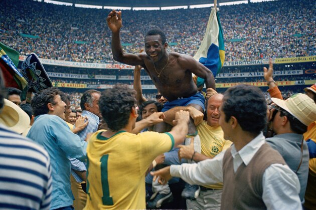 Brazil's Pele is hoisted on shoulders of his teammates after Brazil won the ninth World Cup final against Italy, 4-1, in Mexico City's Estadio Azteca, Mexico, on June 21, 1970.  Pele, who scored the opening goal of the game and assisted two, wins his third winner's medal.  The World Cup victory is Brazil's third win for the Jules Rimet Cup.  (AP Photo)