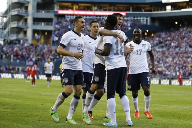 USA's Eddie Johnson (18), second from right, is hugged by USA's Brad Evans, upper right, after Johnson scored a goal against Panama in the second half of a World Cup qualifier soccer match, Tuesday, June 11, 2013, in Seattle. Looking on at left is Geoff Cameron (20) and Clint Dempsey, second from left, and at right is Jozy Altidore (17). USA defeated Panama, 2-0. (AP Photo/Ted S. Warren)