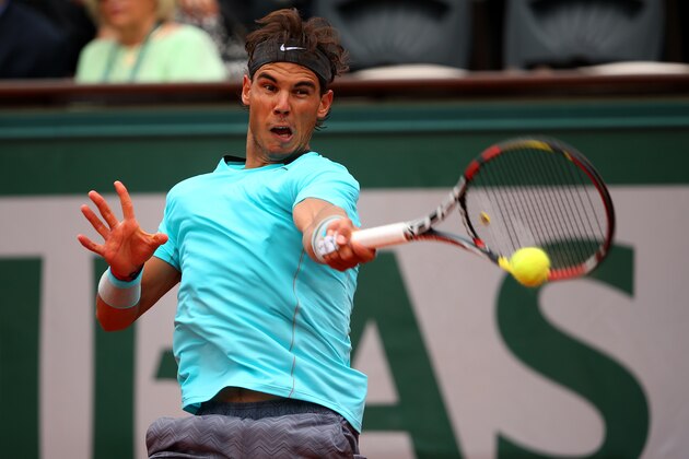 PARIS, FRANCE - JUNE 02:  Rafael Nadal of Spain returns a shot in his men's singles match against Dusan Lajovic of Serbia on day nine of the French Open at Roland Garros on June 2, 2014 in Paris, France.  (Photo by Clive Brunskill/Getty Images)