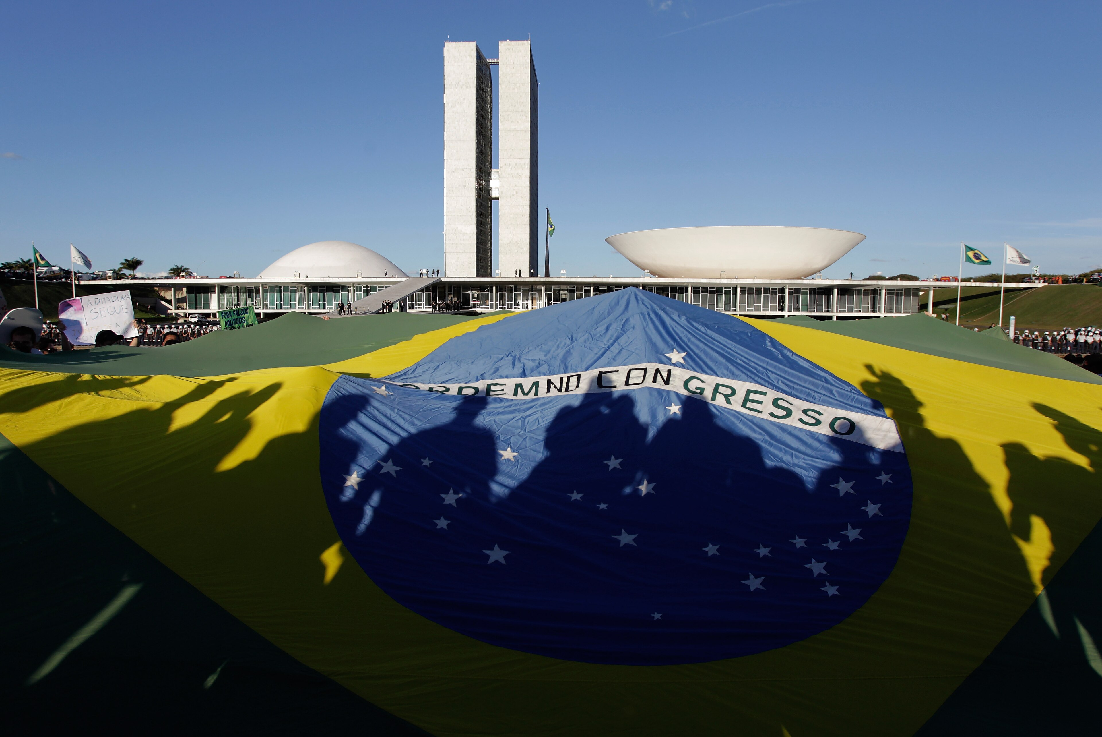 Demonstrators open a Brazil's flag in front of the National Congress during a protest in Brasilia, Brazil, Wednesday, June 26, 2013. The wave of protests that hit Brazil on June 17 began as opposition to transportation fare hikes, then expanded to a list of causes including anger at high taxes, poor services and high World Cup spending, before coalescing around the issue of rampant government corruption. (AP Photo/Eraldo Peres) Demonstrators open a Brazil's flag in front of the National Congress during a protest in Brasilia, Brazil, Wednesday, June 26, 2013. The wave of protests that hit Brazil on June 17 began as opposition to transportation fare hikes, then expanded to a list of causes including anger at high taxes, poor services and high World Cup spending, before coalescing around the issue of rampant government corruption. (AP Photo/Eraldo Peres)