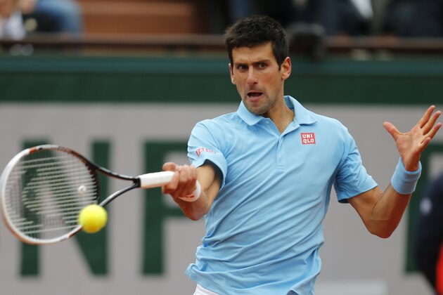 Serbia's Novak Djokovic returns the ball to France's Jo-Wilfried Tsonga during their fourth round match of  the French Open tennis tournament at the Roland Garros stadium, in Paris, France, Sunday, June 1, 2014. Djokovic won 6-1, 6-4, 6-1. (AP Photo/David Vincent)