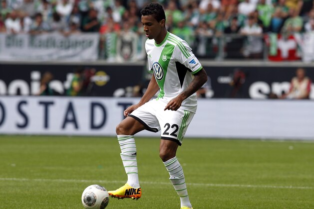Wolfsburg's Luiz Gustavo plays the ball during the German first division Bundesliga soccer match between VfL Wolfsburg and FC Schalke 04 in Wolfsburg, Germany, Saturday, Aug. 17, 2013. (AP Photo/Michael Sohn)