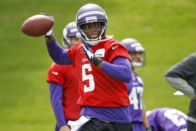 Quarterback Teddy Bridgewater drops back for a pass during Minnesota Vikings minicamp in Eden Prairie, Minn., Friday, May 16, 2014.   (AP Photo/Ann Heisenfelt)