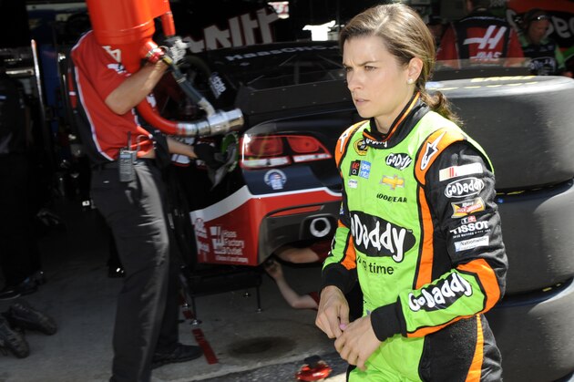 Danica Patrick walks through the garage area after practice for the NASCAR Sprint Cup series auto race, Saturday, May 31, 2014, at Dover International Speedway in Dover, Del. (AP Photo/Nick Wass)
