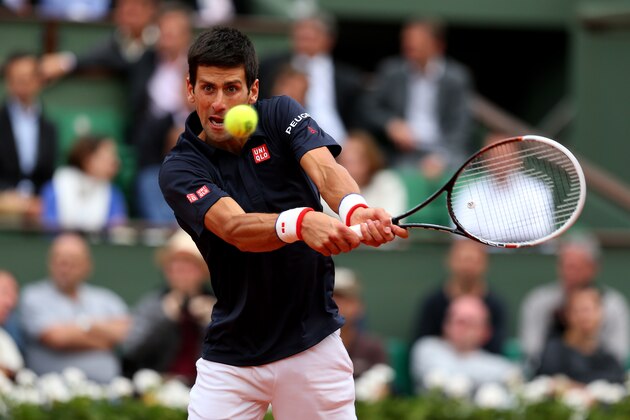 PARIS, FRANCE - JUNE 03:  Novak Djokovic of Serbia returns a shot during his men's singles match against Milos Raonic of Canada on day ten of the French Open at Roland Garros on June 3, 2014 in Paris, France.  (Photo by Clive Brunskill/Getty Images)