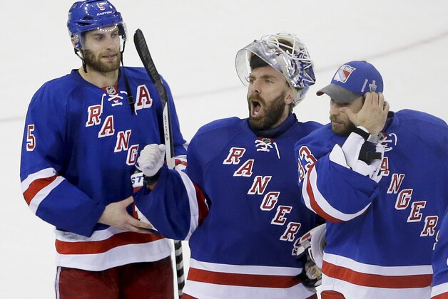 New York Rangers goalie Henrik Lundqvist, center, reacts to the crowd as teammates Dan Girardi (5) and goalie Cam Talbot (33) skate alongside him after the Rangers beat the Montreal Canadiens 1-0 in Game 6 of the NHL hockey Stanley Cup playoffs Eastern Conference finals, Thursday, May 29, 2014, in New York. The Rangers advance to the Stanley Cup Final. (AP Photo/Frank Franklin II)
