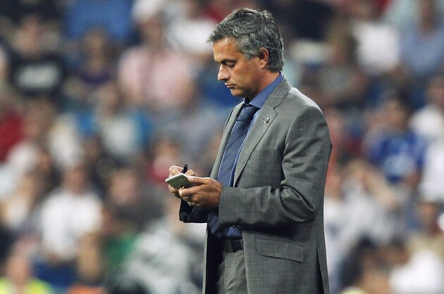 MADRID, SPAIN - SEPTEMBER 15:  Head coach Jose Mourinho of Real Madrid takes notes in a notebook during the UEFA Champions League group G match between Real Madrid and AFC Ajax at Estadio Santiago Bernabeu on September 15, 2010 in Madrid, Spain.  (Photo by Angel Martinez/Getty Images)