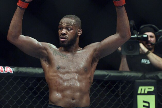 Apr 26, 2014; Baltimore, MD, USA;  Jon Jones puts his arms in the air after the UFC light heavy weight championship fight against Glover Texeira at  Baltimore Arena. Jones retained the light heavy height championship by defeating  Teixeria.  Mandatory Credit: Tommy Gilligan-USA TODAY Sports